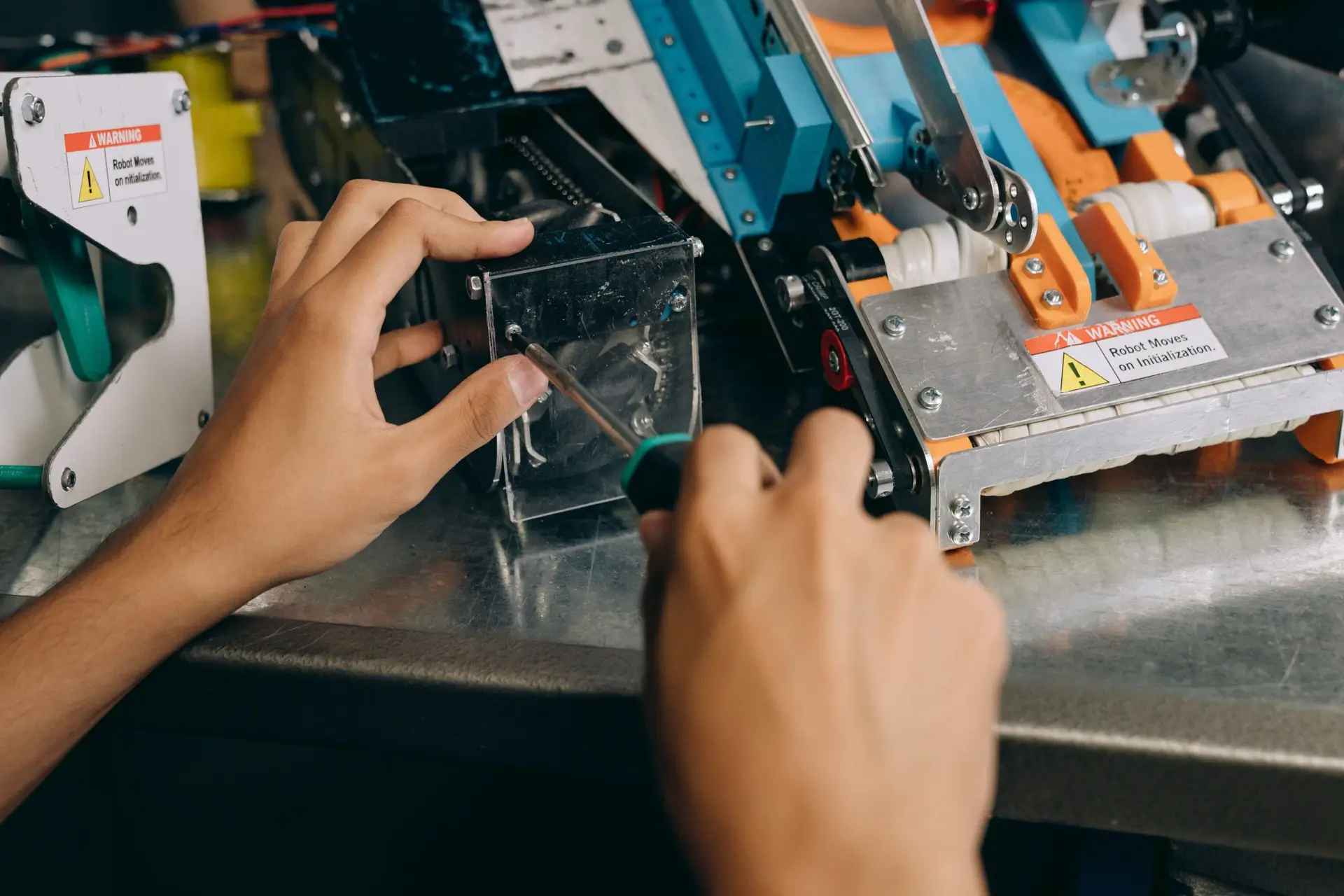 Engineer using a screwdriver to fix equipment
