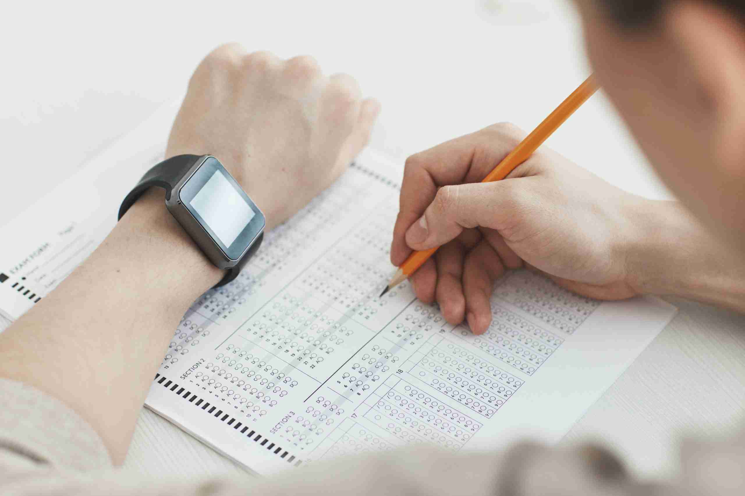 Student sitting an exam with a pencil in hand