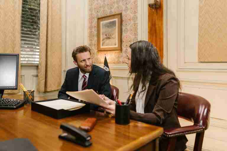 Two individuals discussing in a law office