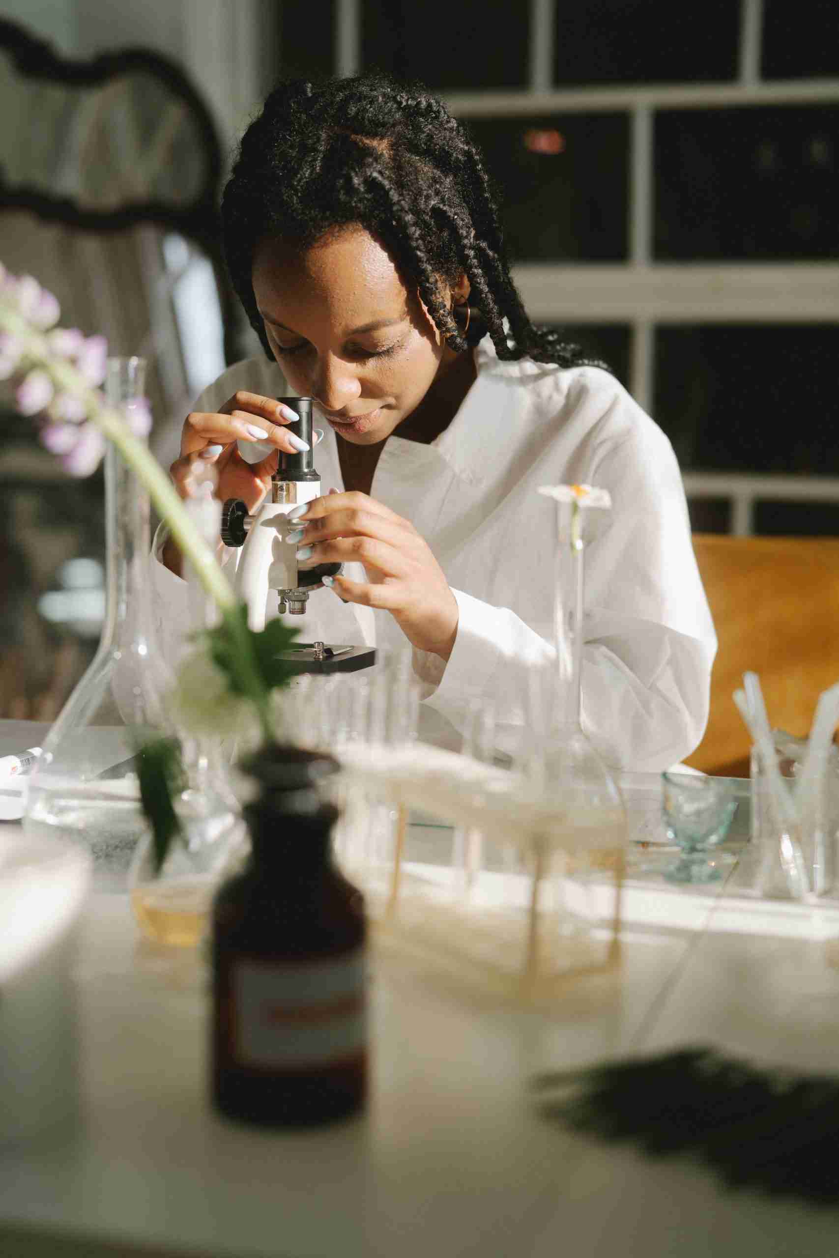 Scientist looking through an optical microscope